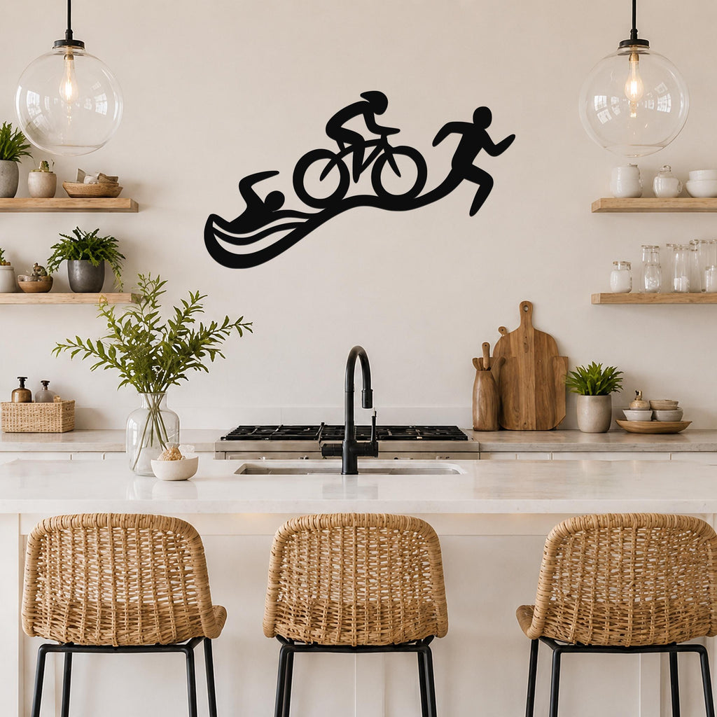 Black metal triathlon wall art with swim, bike, and run silhouettes, mounted above a kitchen counter.