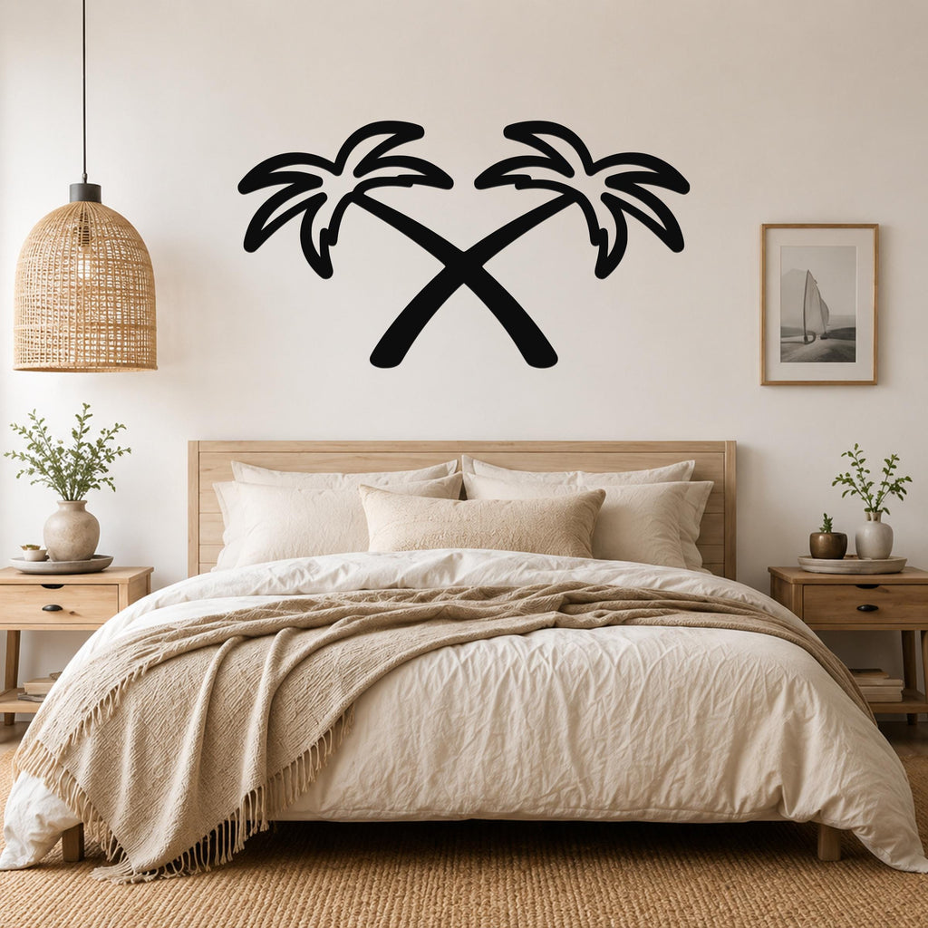 Black metal wall art featuring a silhouette of two crossed palm trees, mounted above a bed in a bedroom.