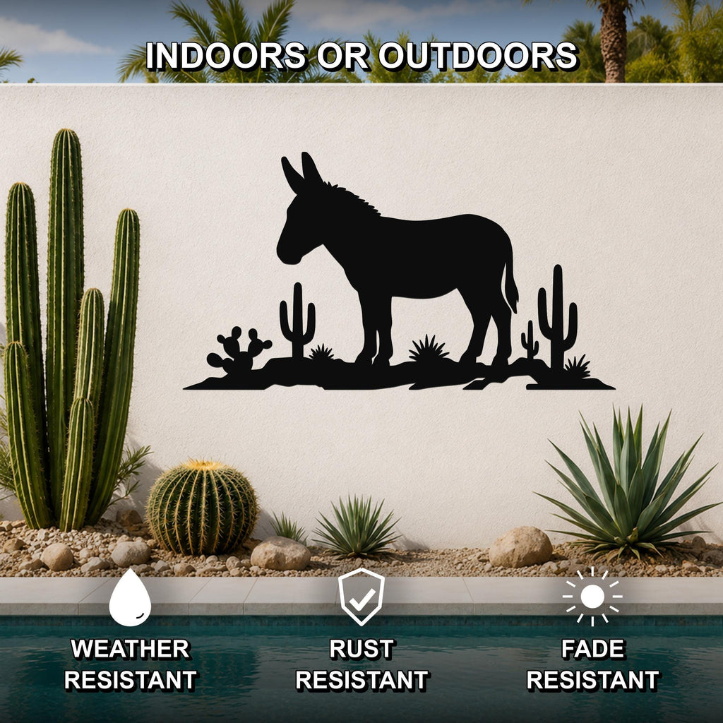 Black metal wall sculpture of a burro silhouette with cacti, mounted on an outdoor wall above a pool in a desert-themed garden.