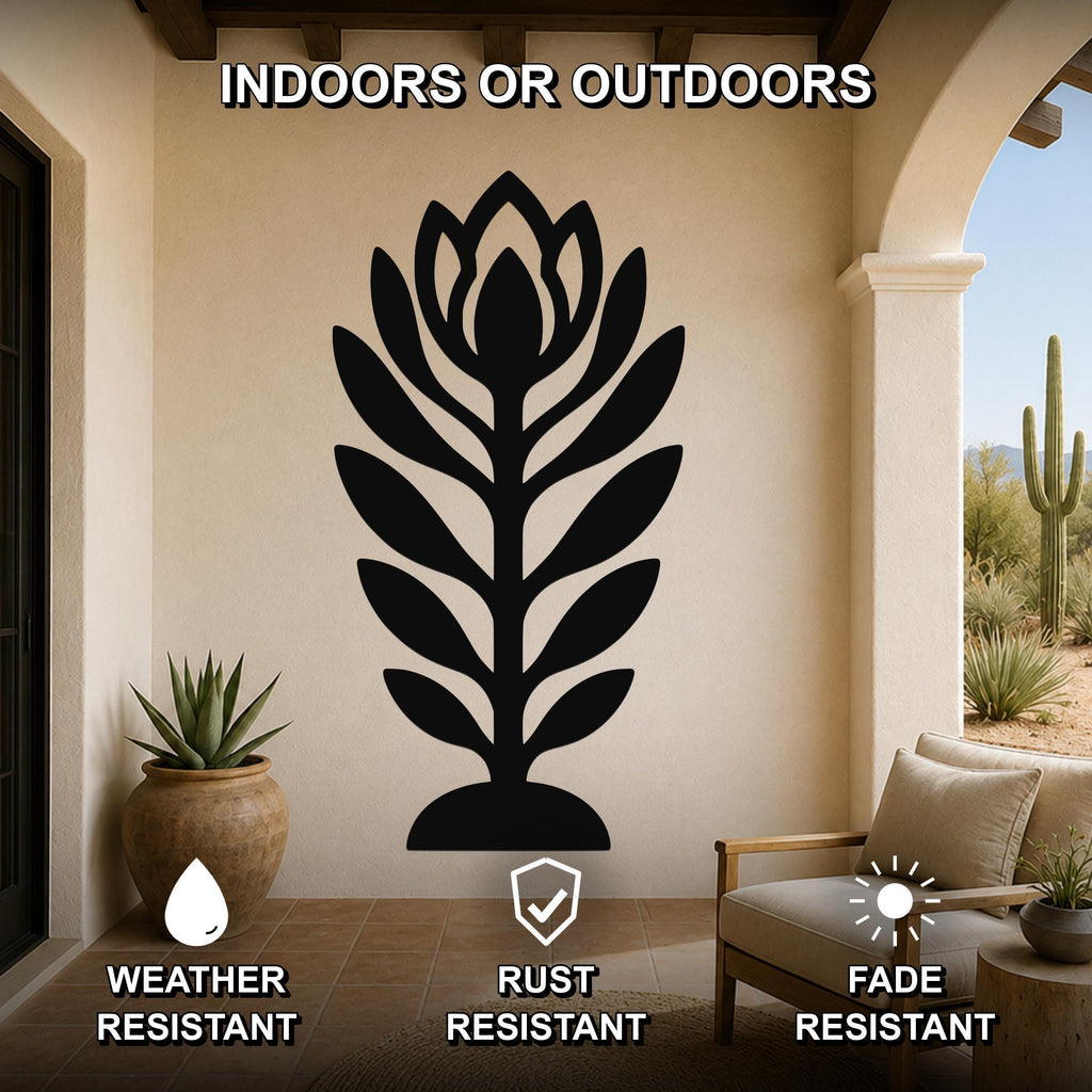 Black metal wall art in a leafy plant silhouette, mounted on a beige outdoor wall above a patio chair, with weather, rust, and fade resistance features.