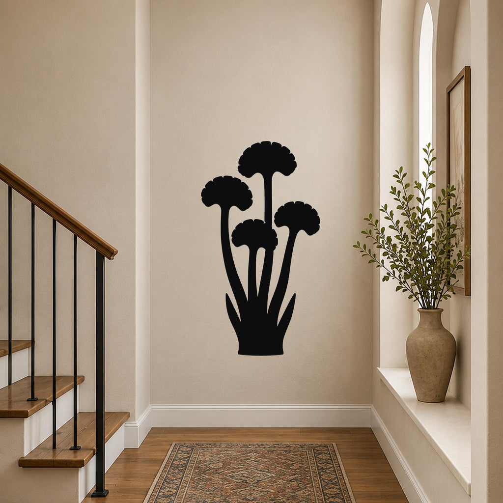 Black metal wall art featuring a ginkgo leaf silhouette, mounted on a hallway wall above a patterned rug near a staircase.