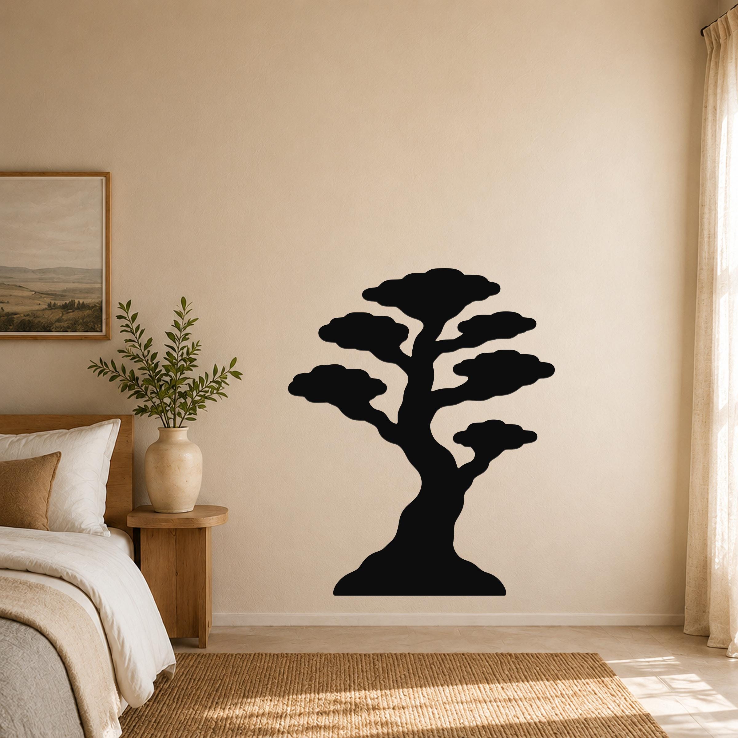 Black metal bonsai tree wall art silhouette mounted on a beige bedroom wall above a bed.