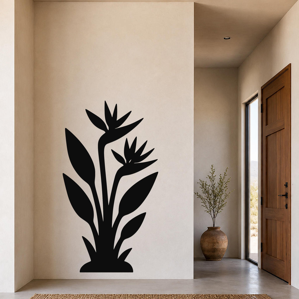 Black metal wall art silhouette of a bird of paradise plant with large leaves and flowers, mounted on a beige wall in a modern entryway.