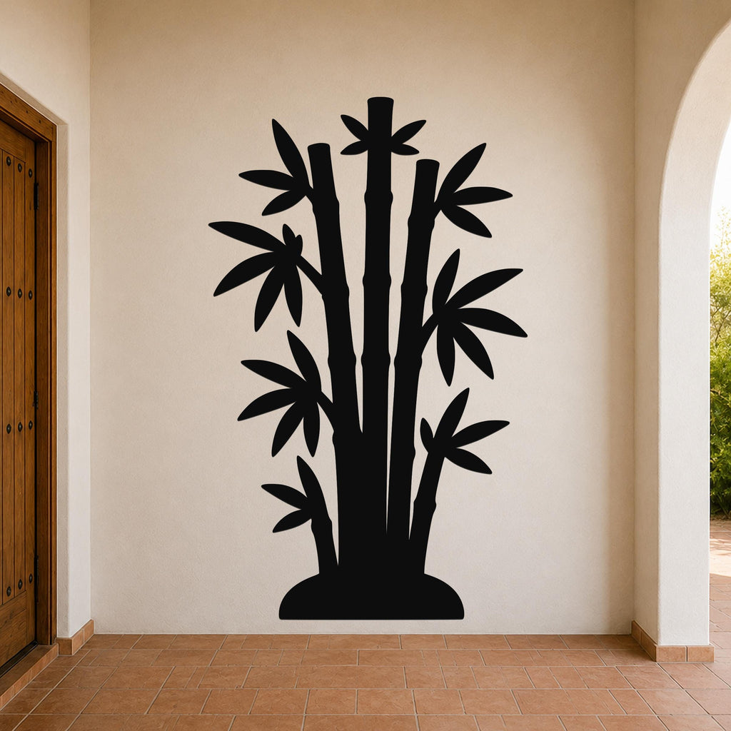 Black metal wall art silhouette of a bamboo cluster with multiple stalks and leaves, mounted on a beige wall in a covered entryway with terracotta flooring.