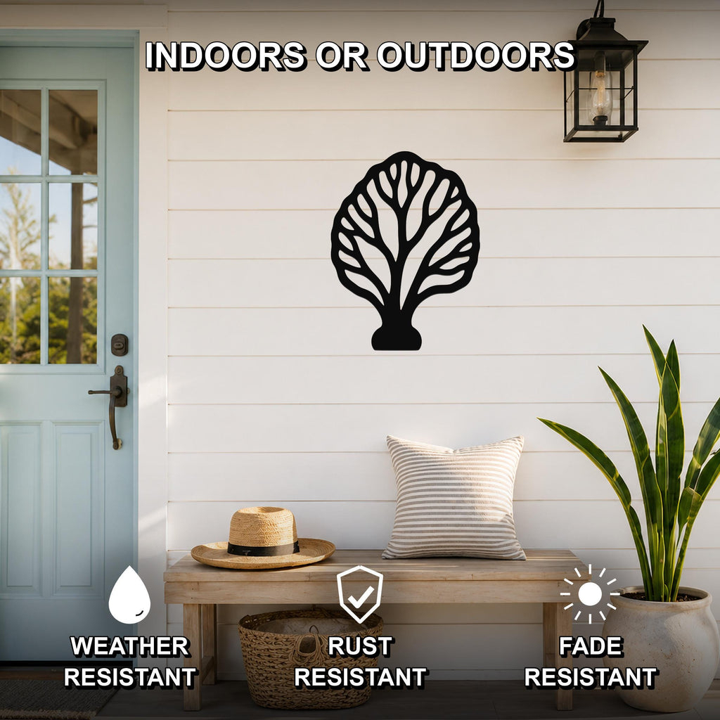 Black metal fan coral wall art with intricate branch cutouts, mounted on a white shiplap wall above a wooden bench on a porch.