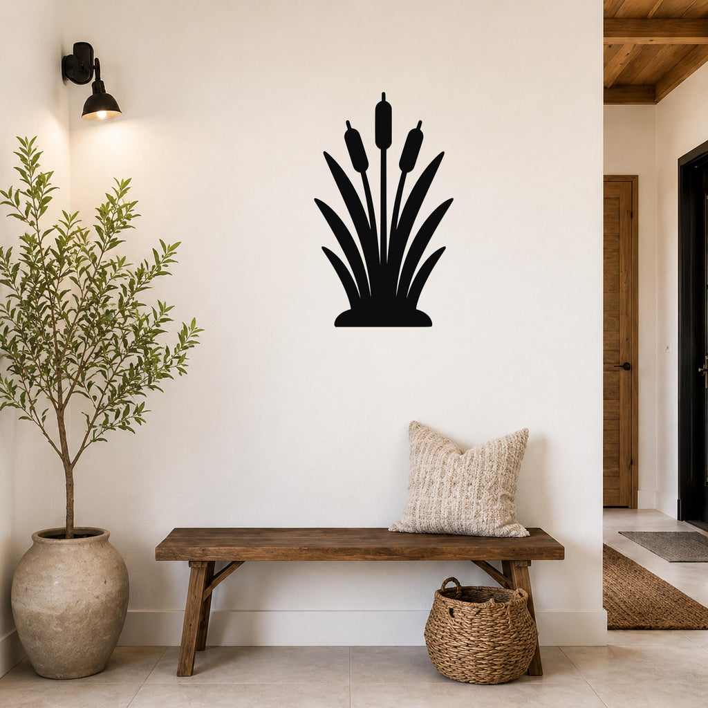 Black metal cattail wall art silhouette mounted on a white wall above a wooden bench in a living room entryway.