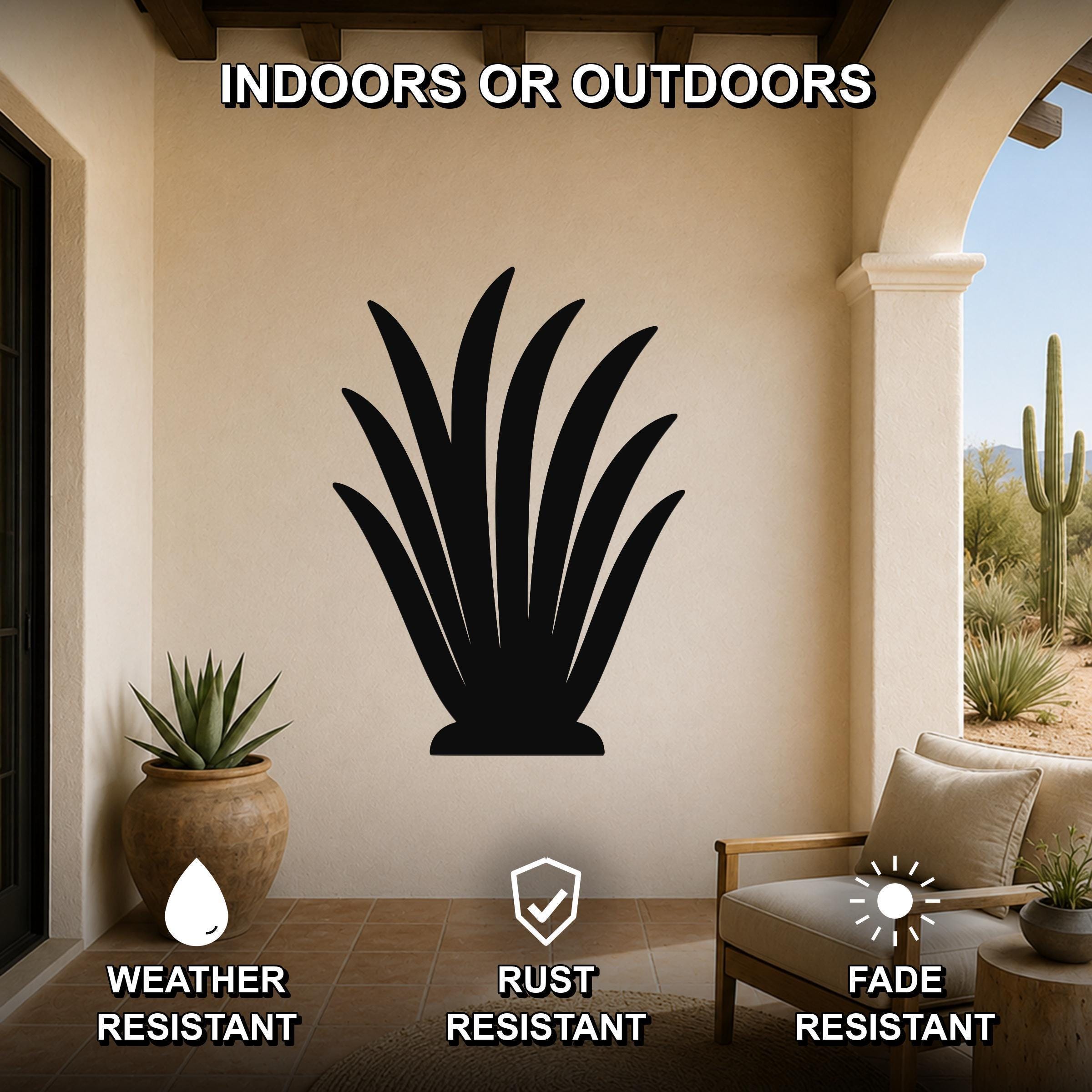 Black metal agave wall art silhouette mounted on a beige patio wall, weather resistant, rust resistant, and fade resistant, displayed above a wooden chair in an outdoor living space.