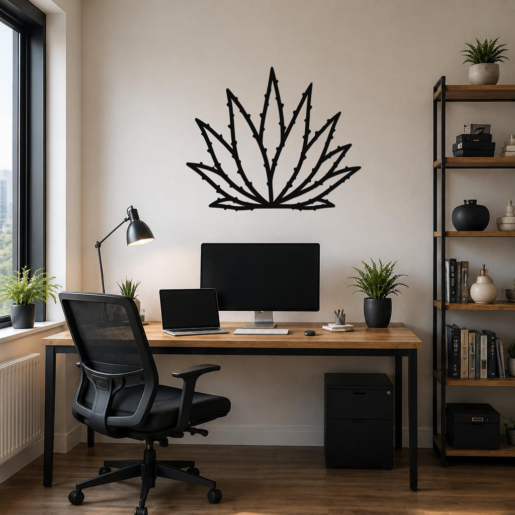 Black metal agave wall art with spiky leaf cutouts, mounted above a wooden desk in a modern home office.