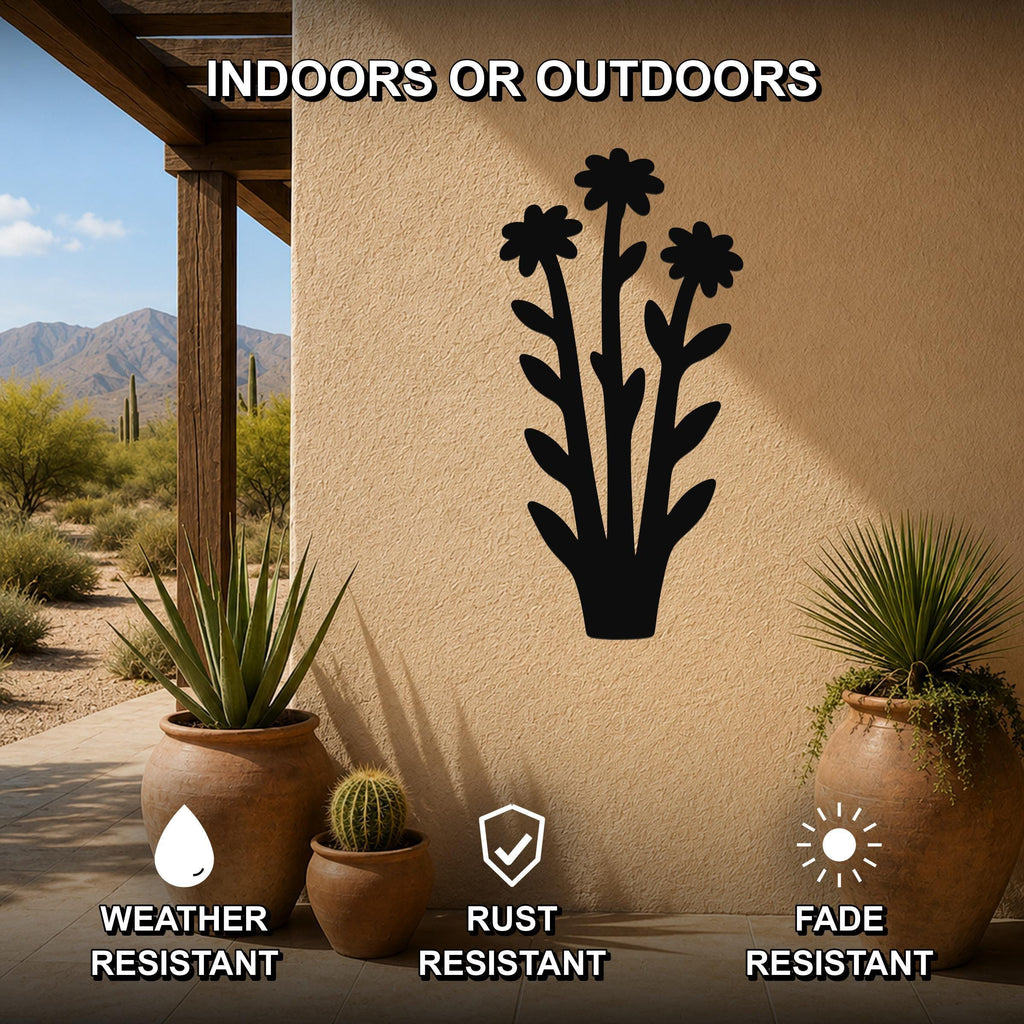 Black metal wildflower wall art with three flower cutouts and leafy stems, mounted on an outdoor patio wall above potted plants, weather, rust, and fade resistant.