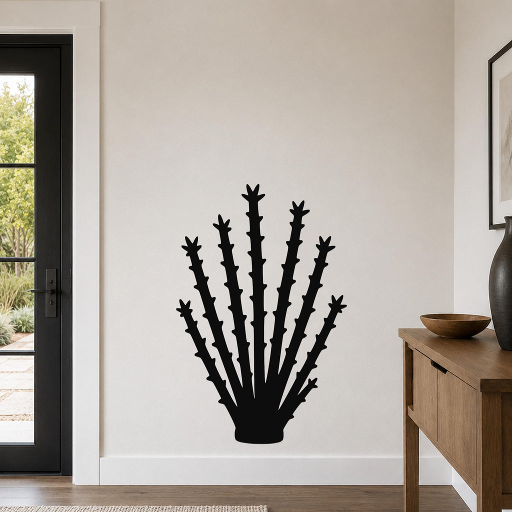 Black metal ocotillo wall art with spiky branch cutouts, mounted on a white wall in a living room near a door and console table.