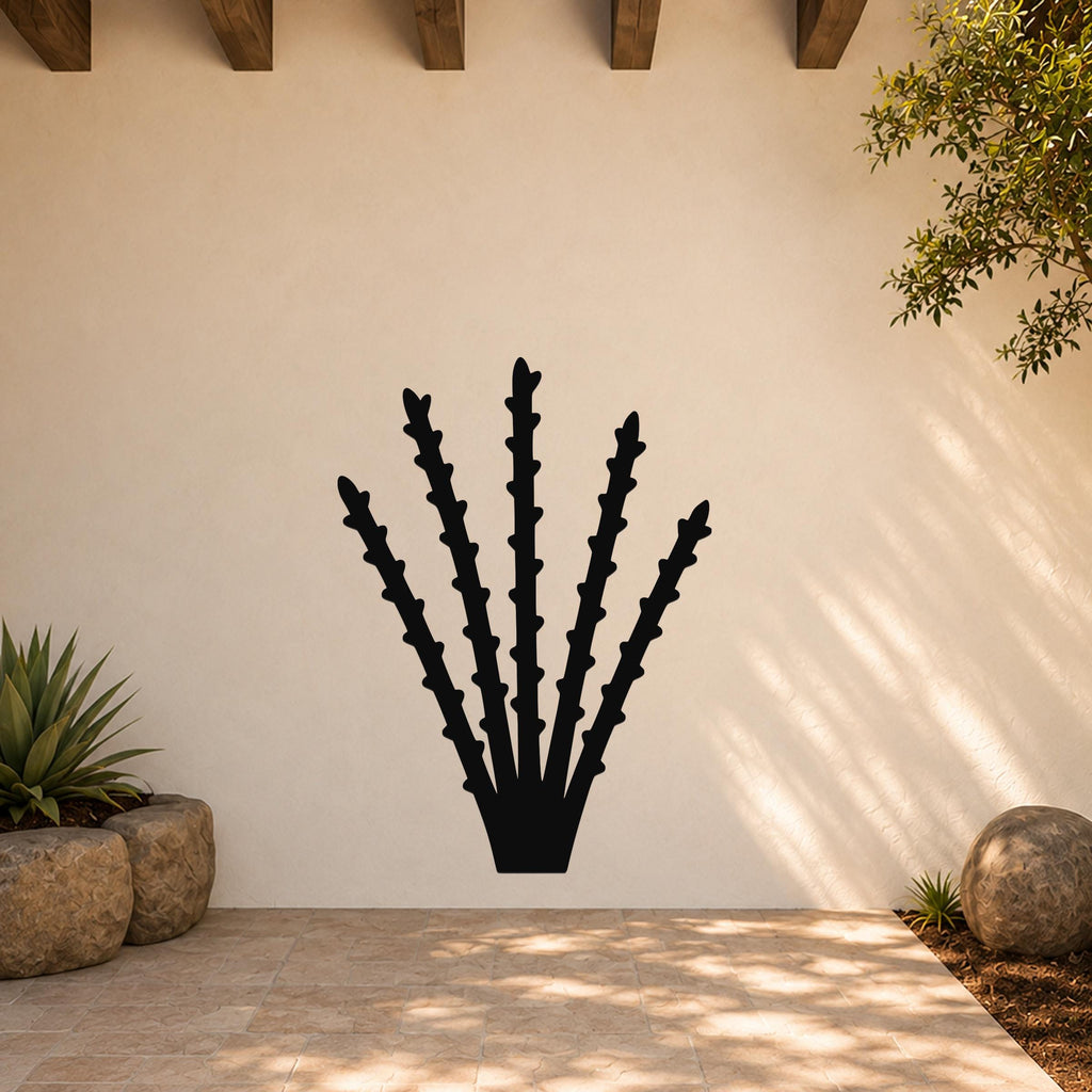 Black metal ocotillo wall art with spiky branch cutouts, mounted on a beige outdoor wall above a tiled patio.