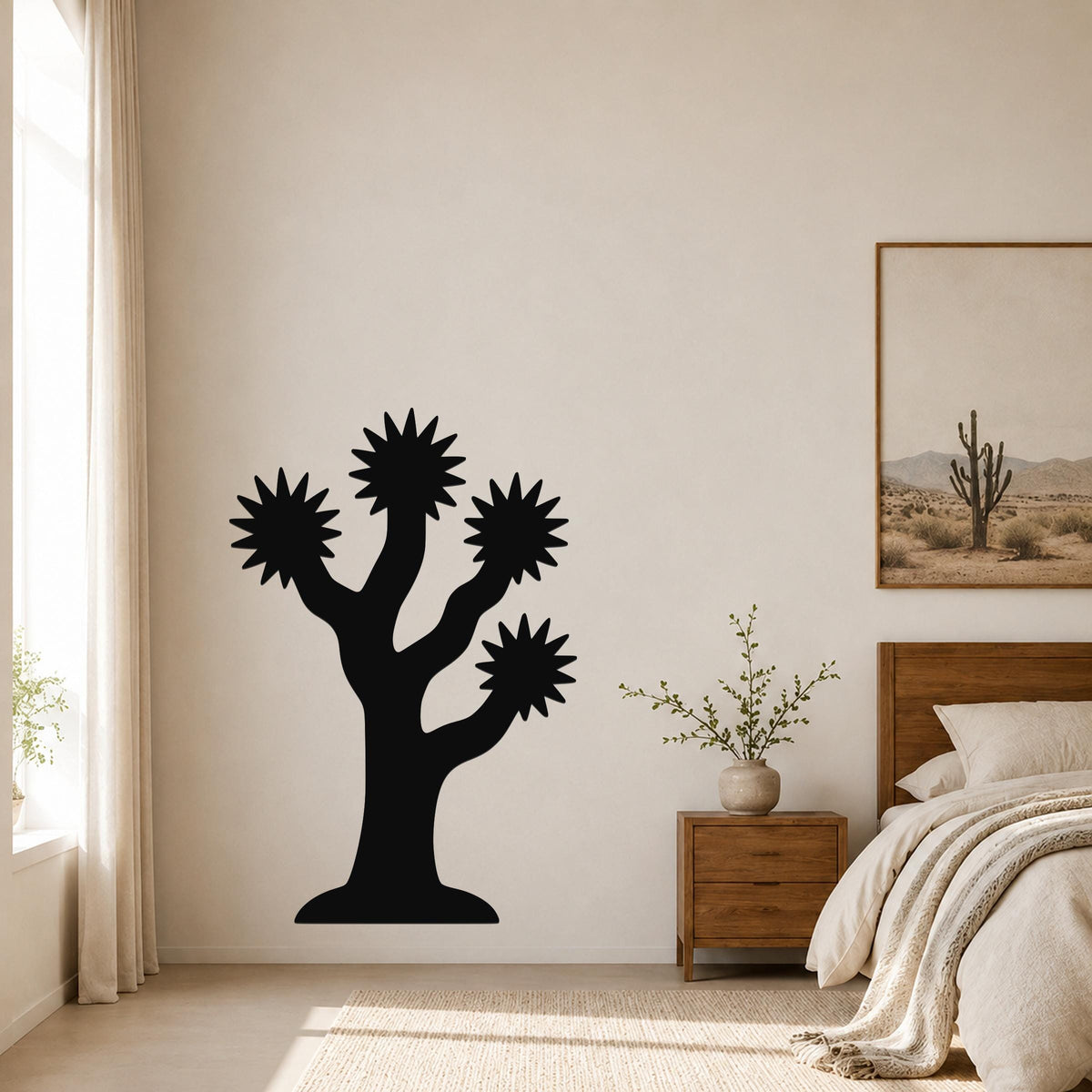Black metal Joshua tree wall art with starburst-shaped branches, mounted on a bedroom wall above a nightstand.