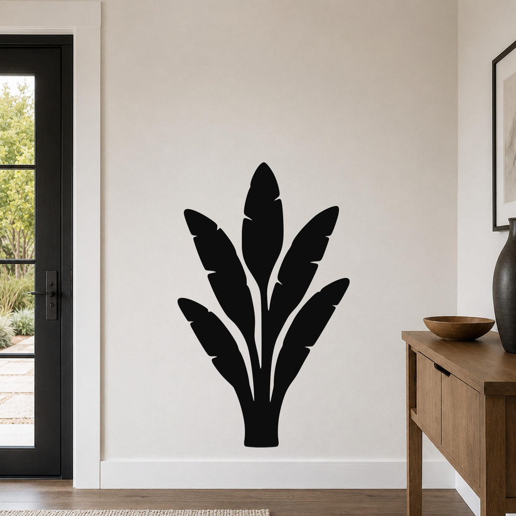 Black metal banana plant wall art with leaf cutouts, mounted on a light-colored wall in a modern entryway.