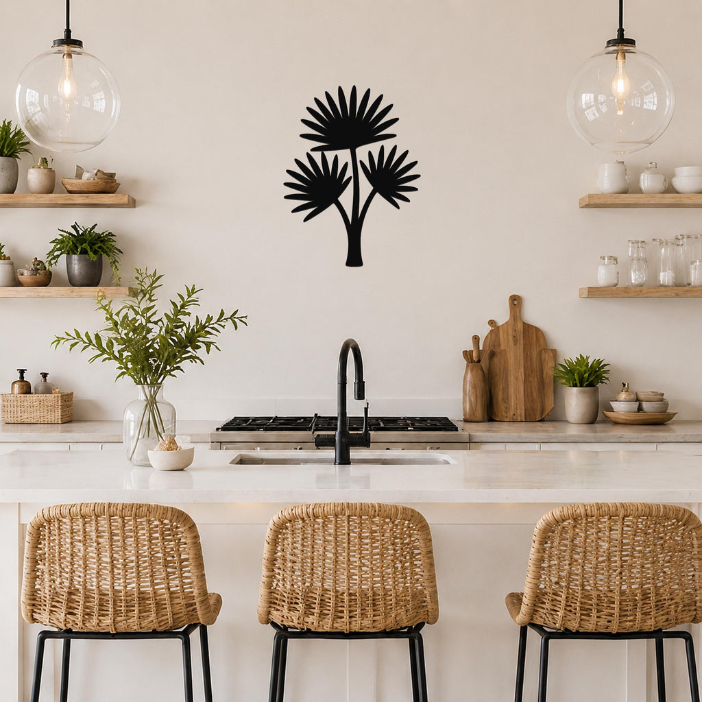 Black metal cutout palm tree wall art with three fan-shaped fronds, mounted on a kitchen wall above a counter.