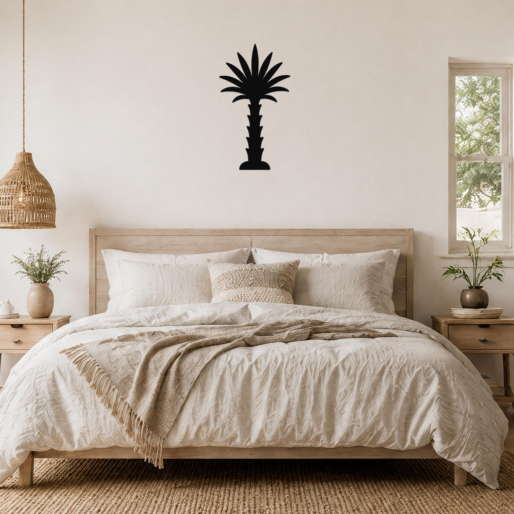 Black metal palm tree wall art silhouette mounted above a wooden bed in a neutral bedroom.