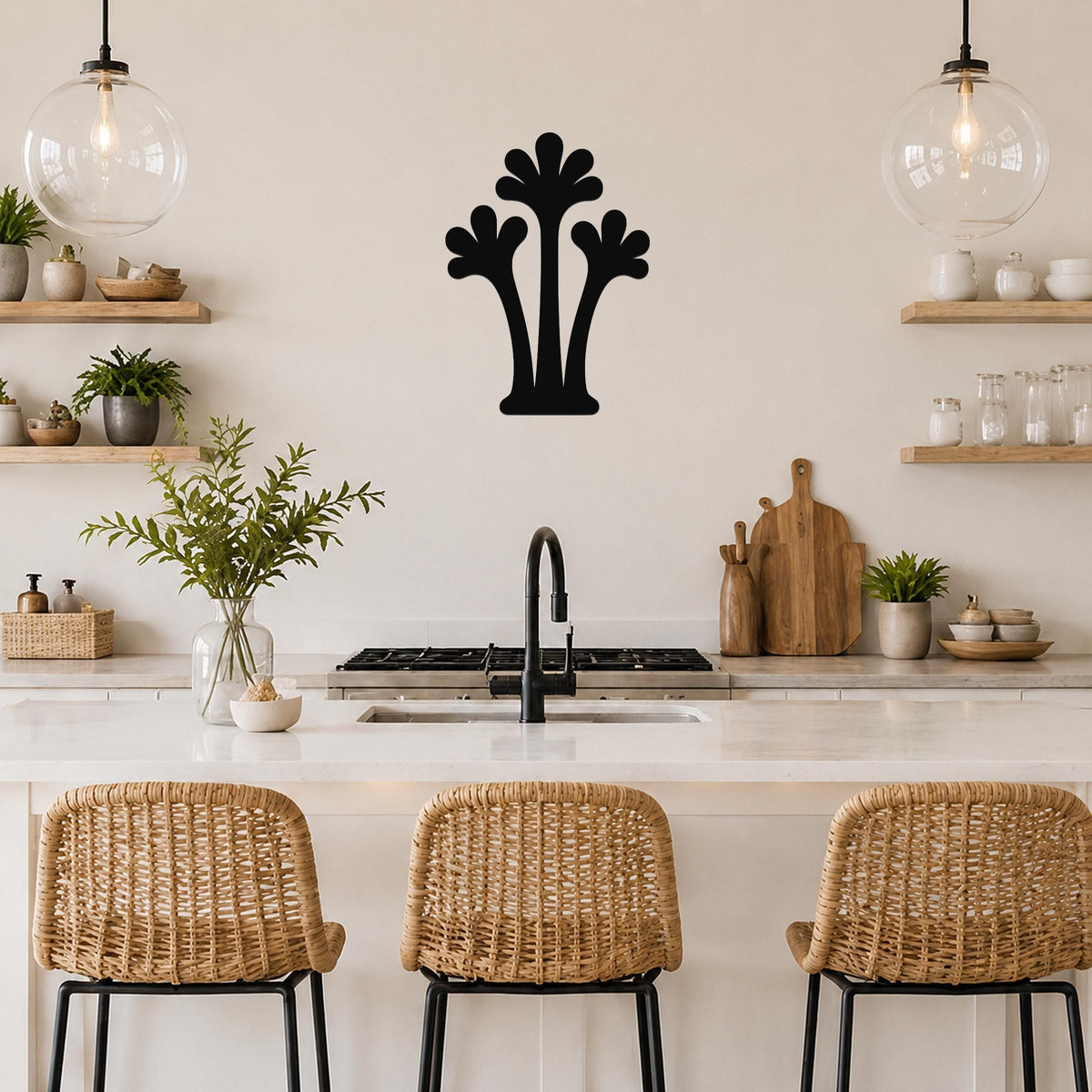 Black metal palm tree wall art with three fronded silhouettes, mounted on a kitchen wall above a counter.