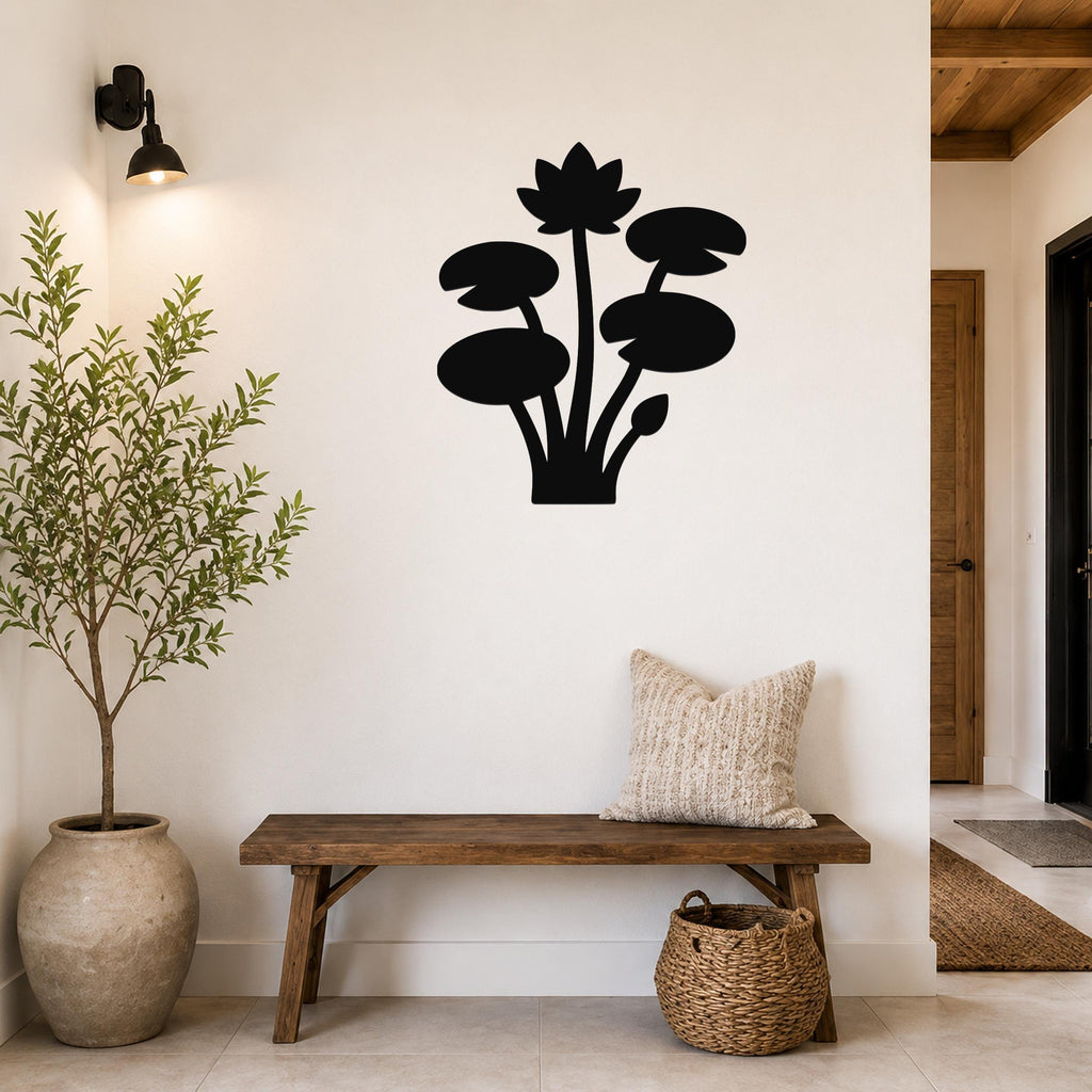 Black metal lotus water lily wall art silhouette mounted on a white wall above a wooden bench in a entryway.