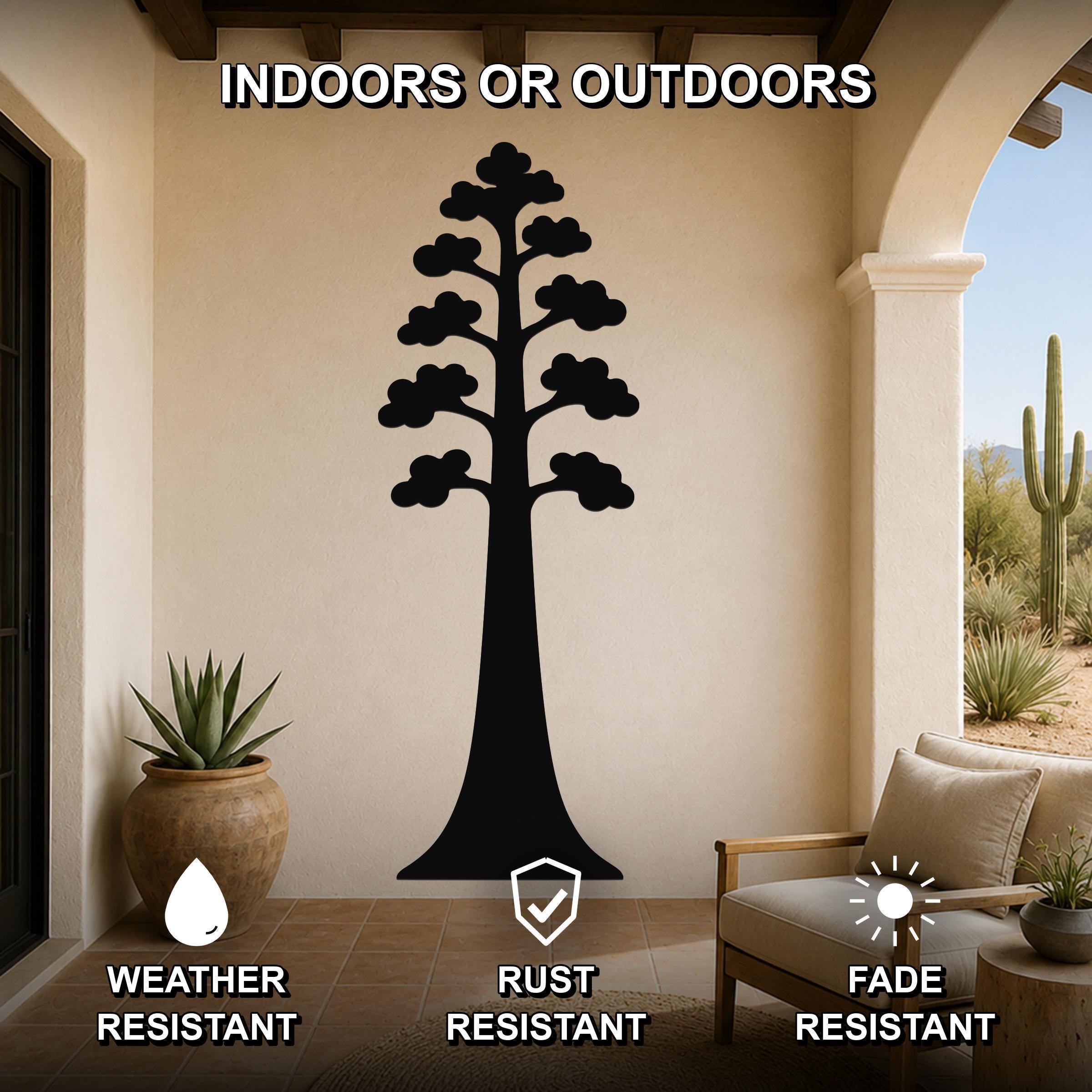 Black metal sequoia tree wall art with layered branch cutouts, mounted on a beige wall in a covered patio with outdoor furniture and potted plants.