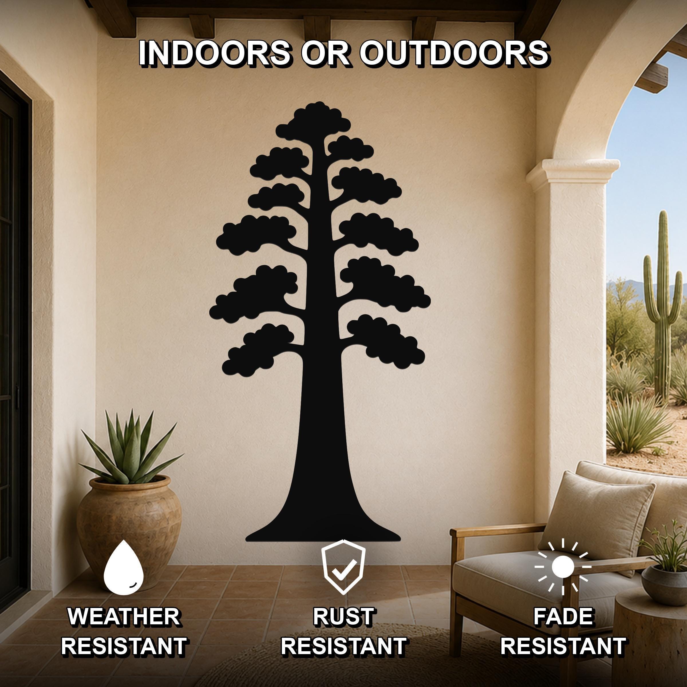 Black metal sequoia tree wall art with layered branch cutouts, mounted on a beige patio wall above a wooden chair and potted plant.