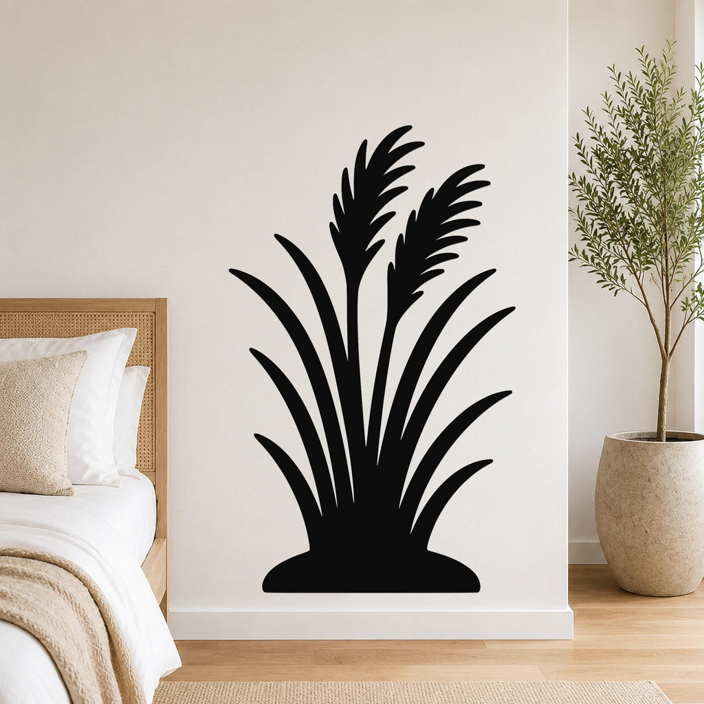 Black metal wall art in a wild grass silhouette design, mounted on a bedroom wall above a bed.