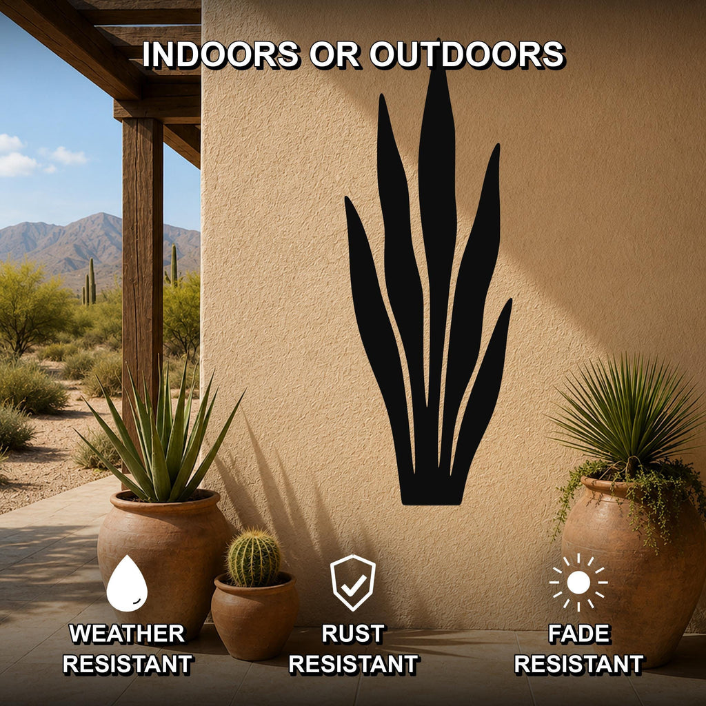 Black metal snake plant wall art silhouette mounted on an outdoor patio wall, shown with potted plants and desert scenery, weather, rust, and fade resistant.