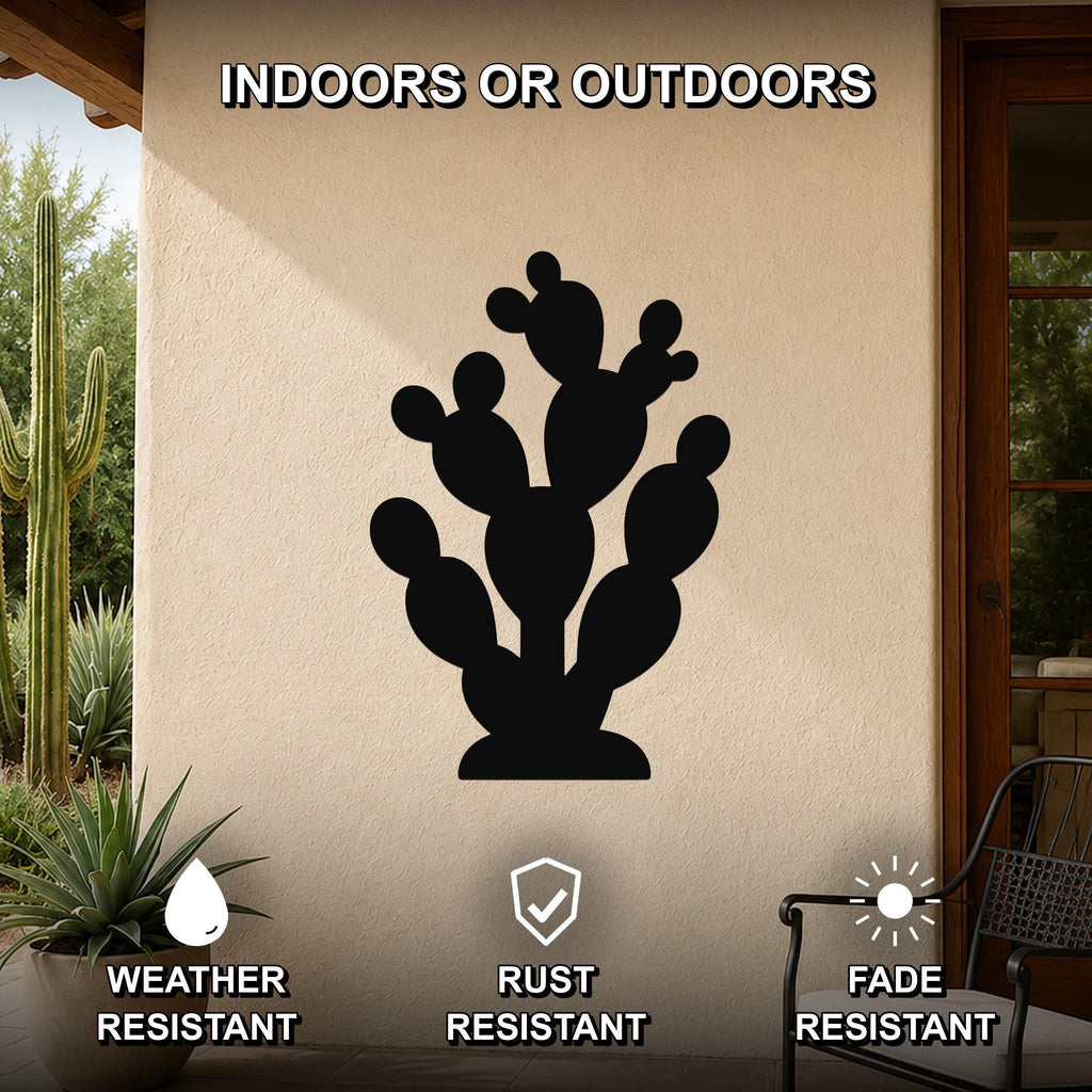 Black metal prickly pear cactus wall art with multiple segmented pads and internal cutouts, mounted on an outdoor patio wall above a potted plant.