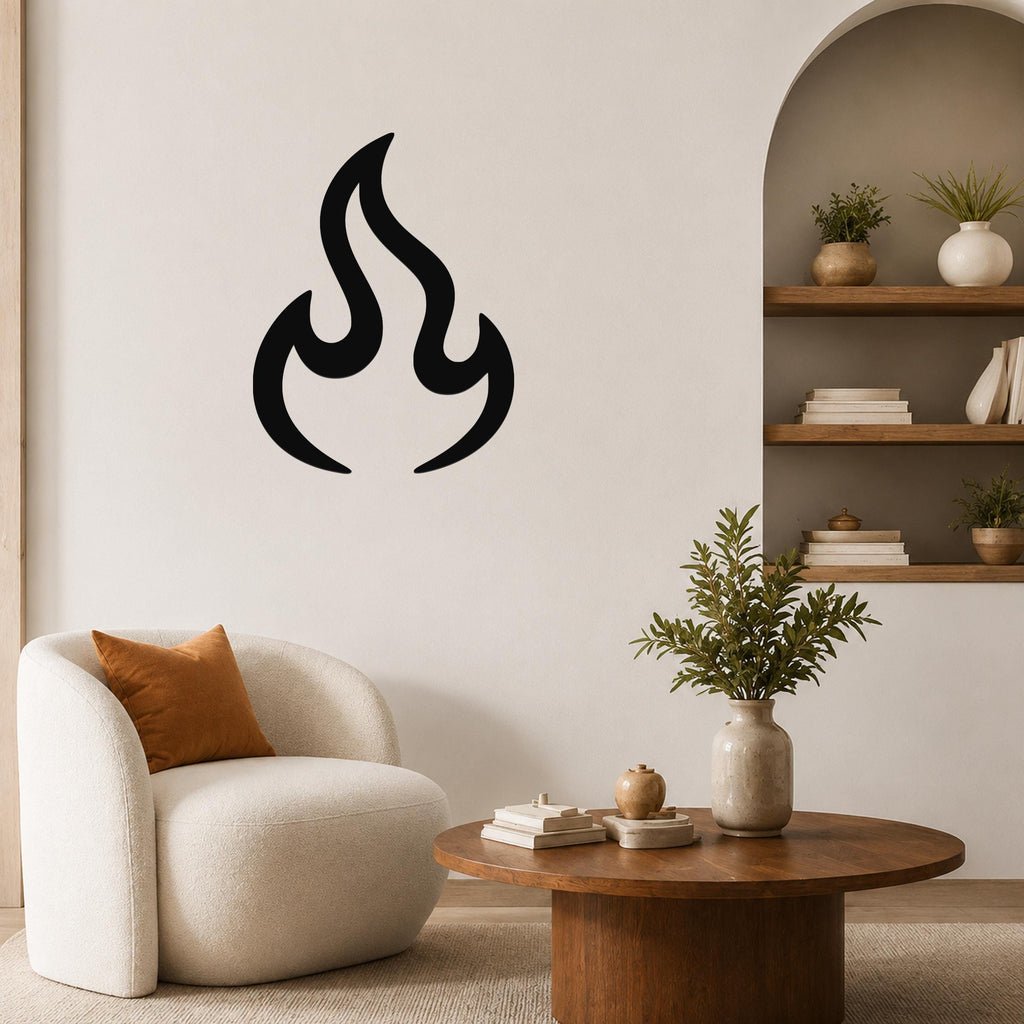 Black metal flame wall art with a bold silhouette design, mounted on a living room wall above a white armchair.