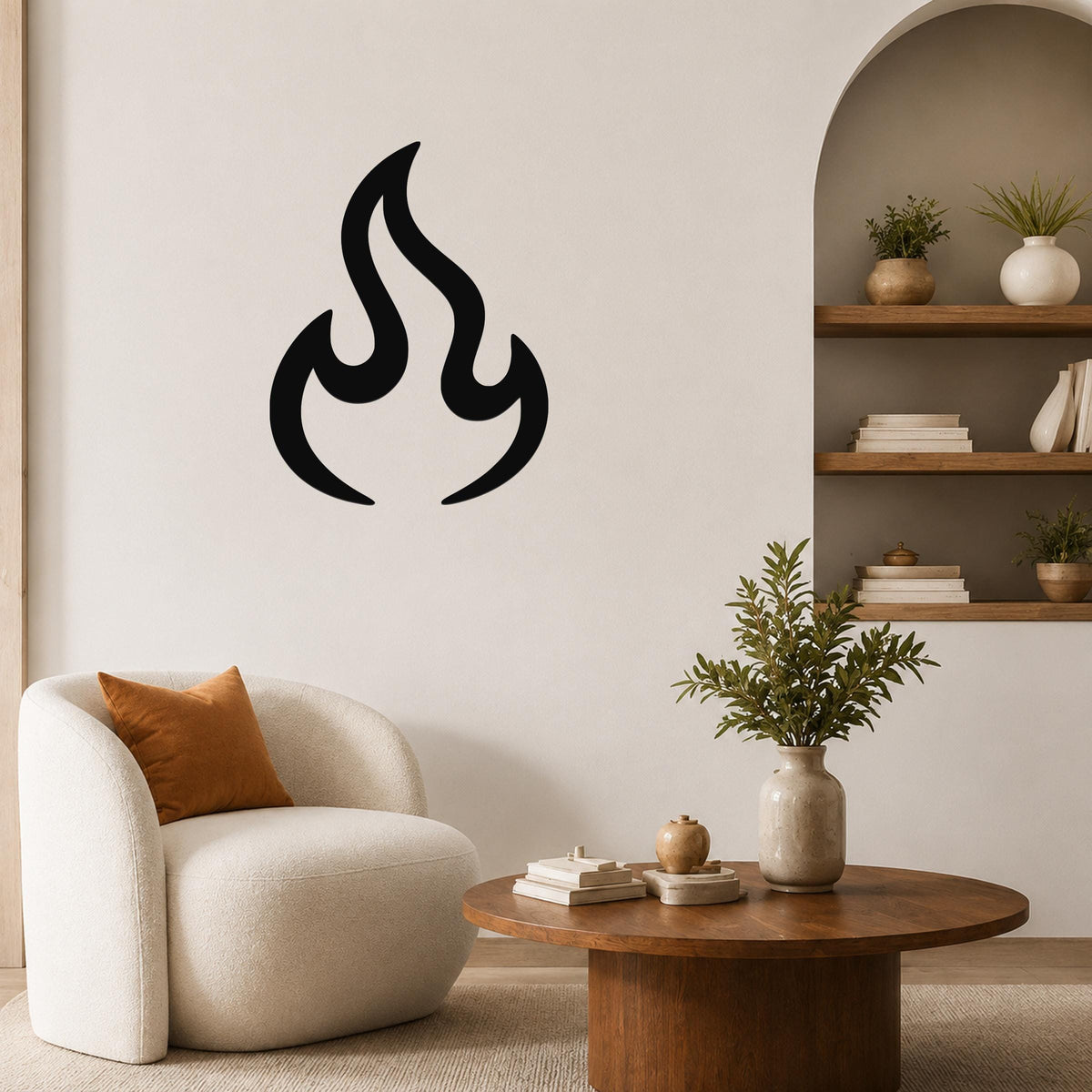 Black metal flame wall art with a bold silhouette design, mounted on a living room wall above a white armchair.
