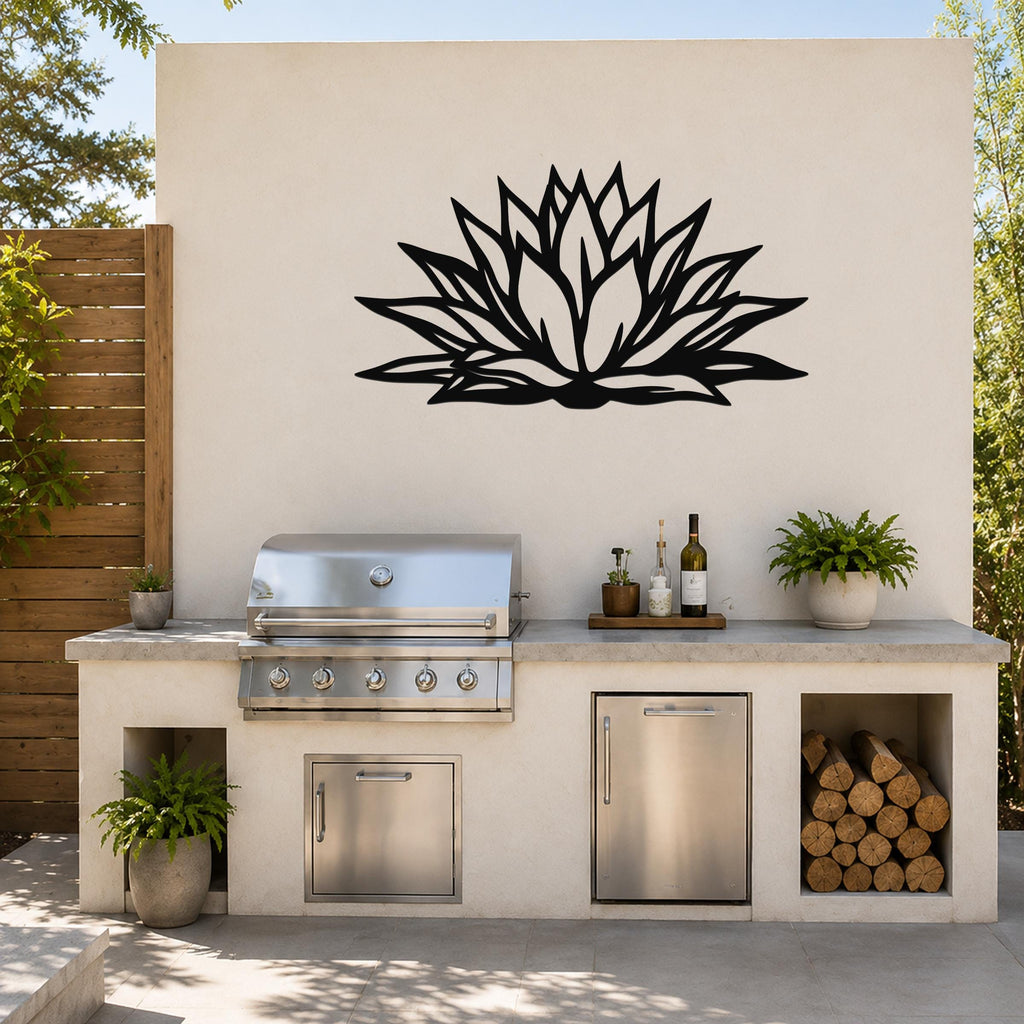 Black metal agave wall art with bold geometric cutouts, mounted on an outdoor patio wall above a stainless steel grill and countertop.