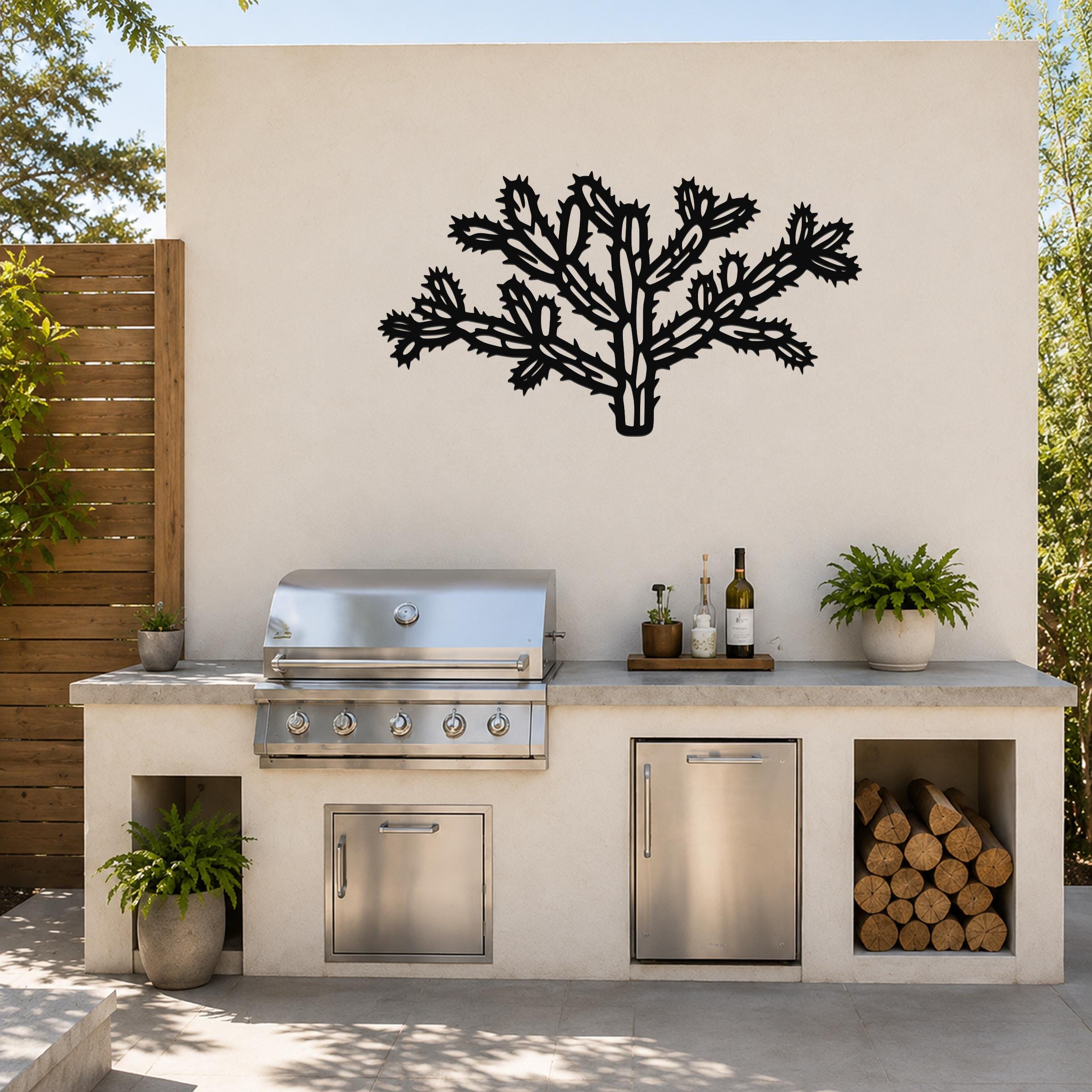 Black metal Cholla cactus wall art with intricate branch cutouts, mounted on a beige outdoor wall above a kitchen counter.