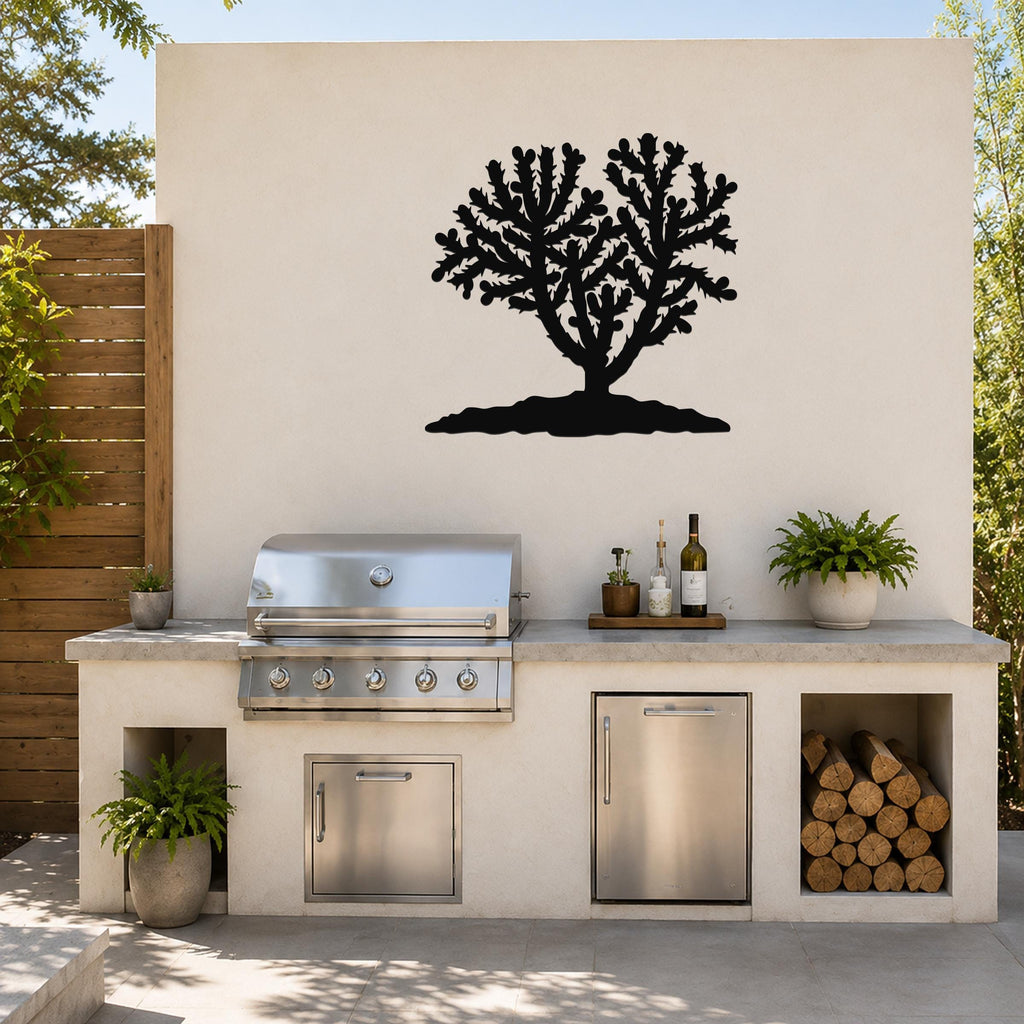Black metal Cholla cactus wall art silhouette mounted on a light-colored outdoor wall above a kitchen counter.