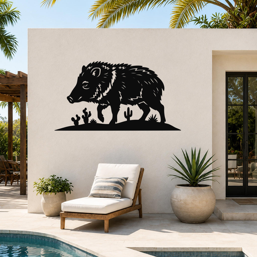 Black metal javelina wall art with cactus cutouts, mounted on an outdoor patio wall above a lounge chair.