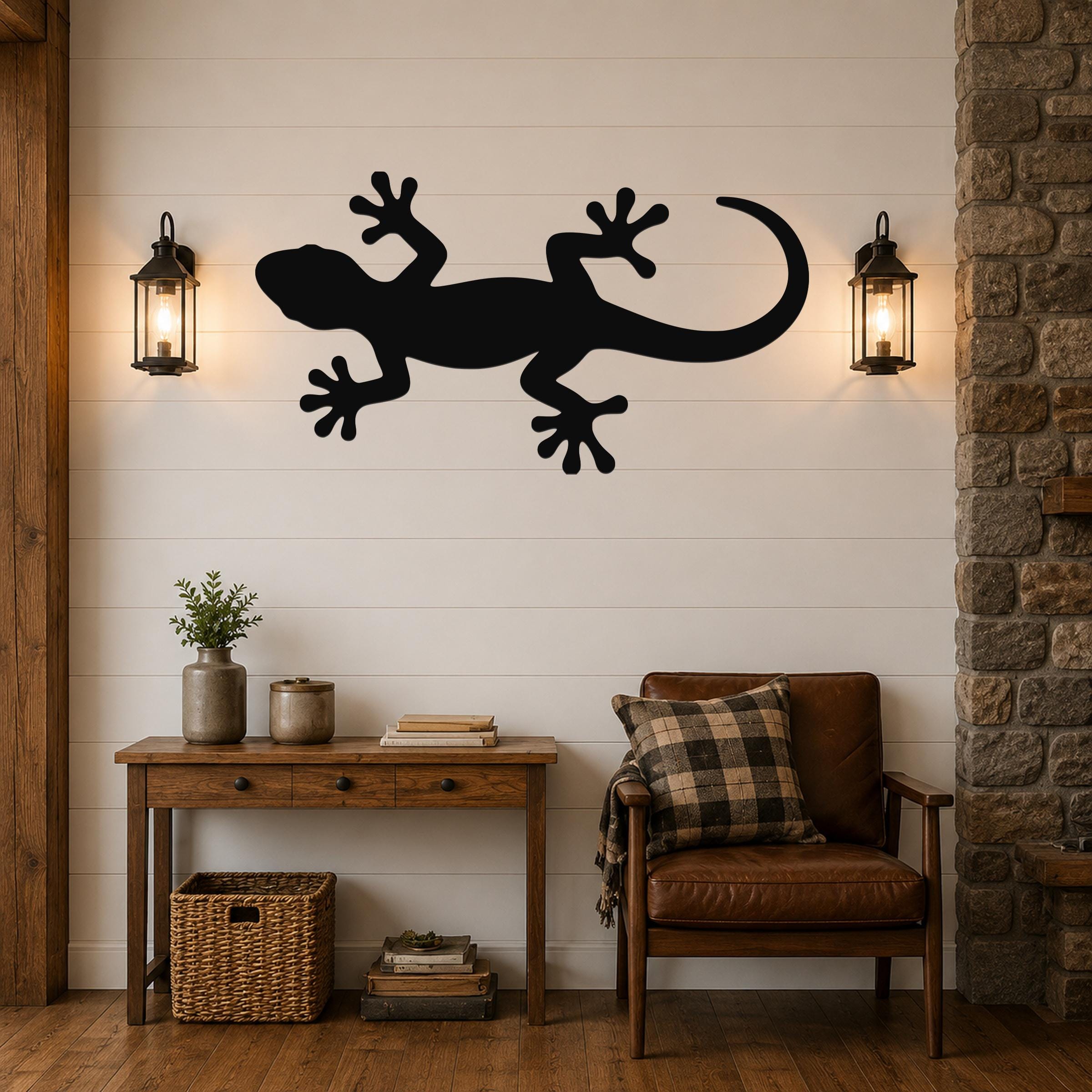 Black metal lizard wall art silhouette mounted on a shiplap wall above a wooden console table in a living room.