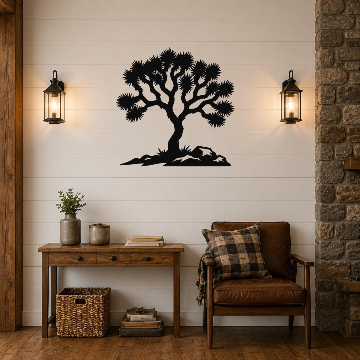 Black metal wall art silhouette of a Joshua tree with spiky branches and rocky base, mounted on a shiplap wall above a wooden console table in a living room.