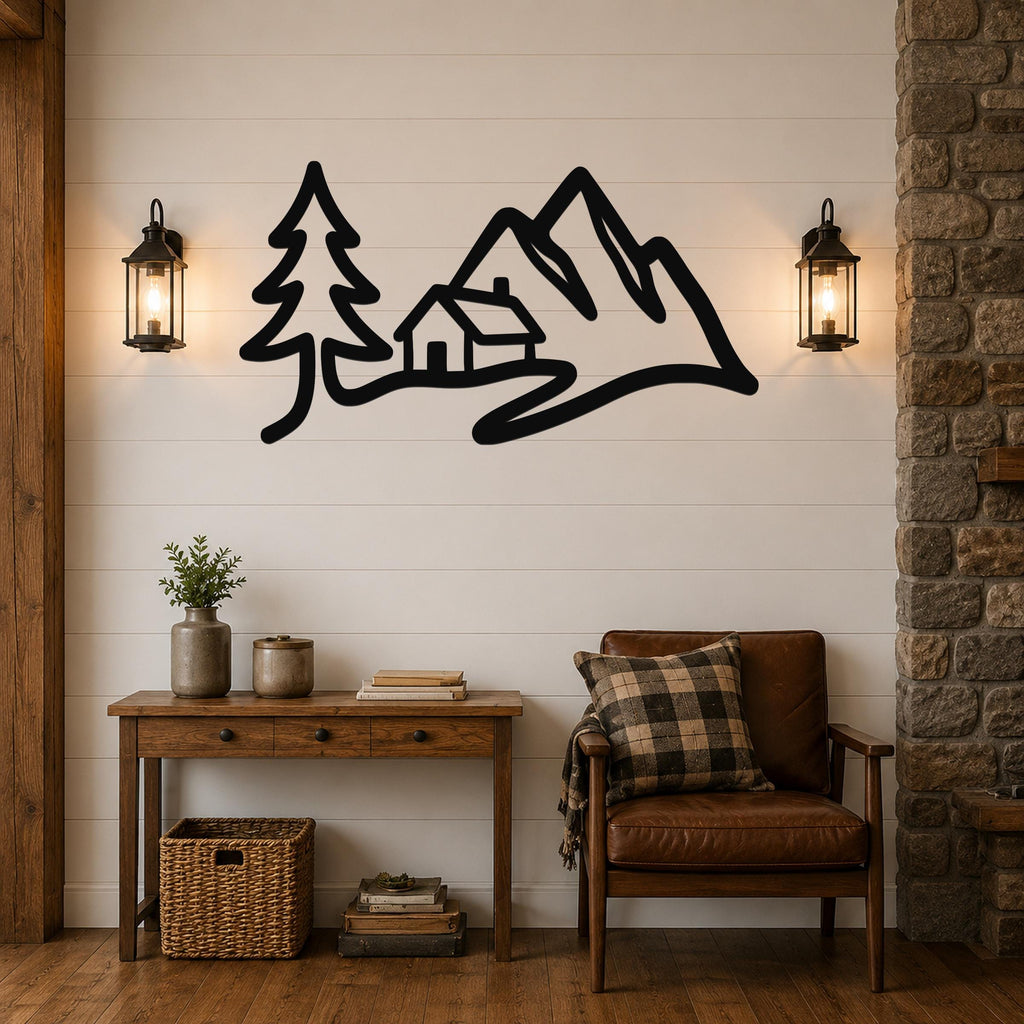 Black metal wall art silhouette of a mountain range, cabin, and pine tree, mounted on a shiplap wall above a wooden console table in a living room.