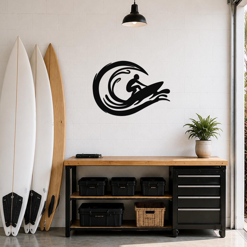 Black metal surfer wall art with wave cutouts, mounted on a white brick wall above a wooden workbench in a garage.