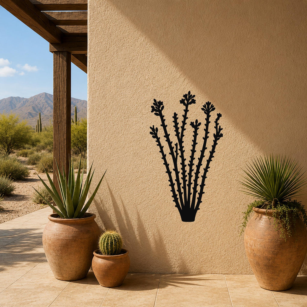 Black metal ocotillo wall art with flower and branch cutouts, mounted on a beige outdoor wall beside potted plants on a patio.