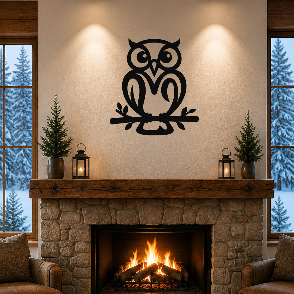 Black metal owl wall art with branch cutout, mounted above a stone fireplace in a cozy living room.