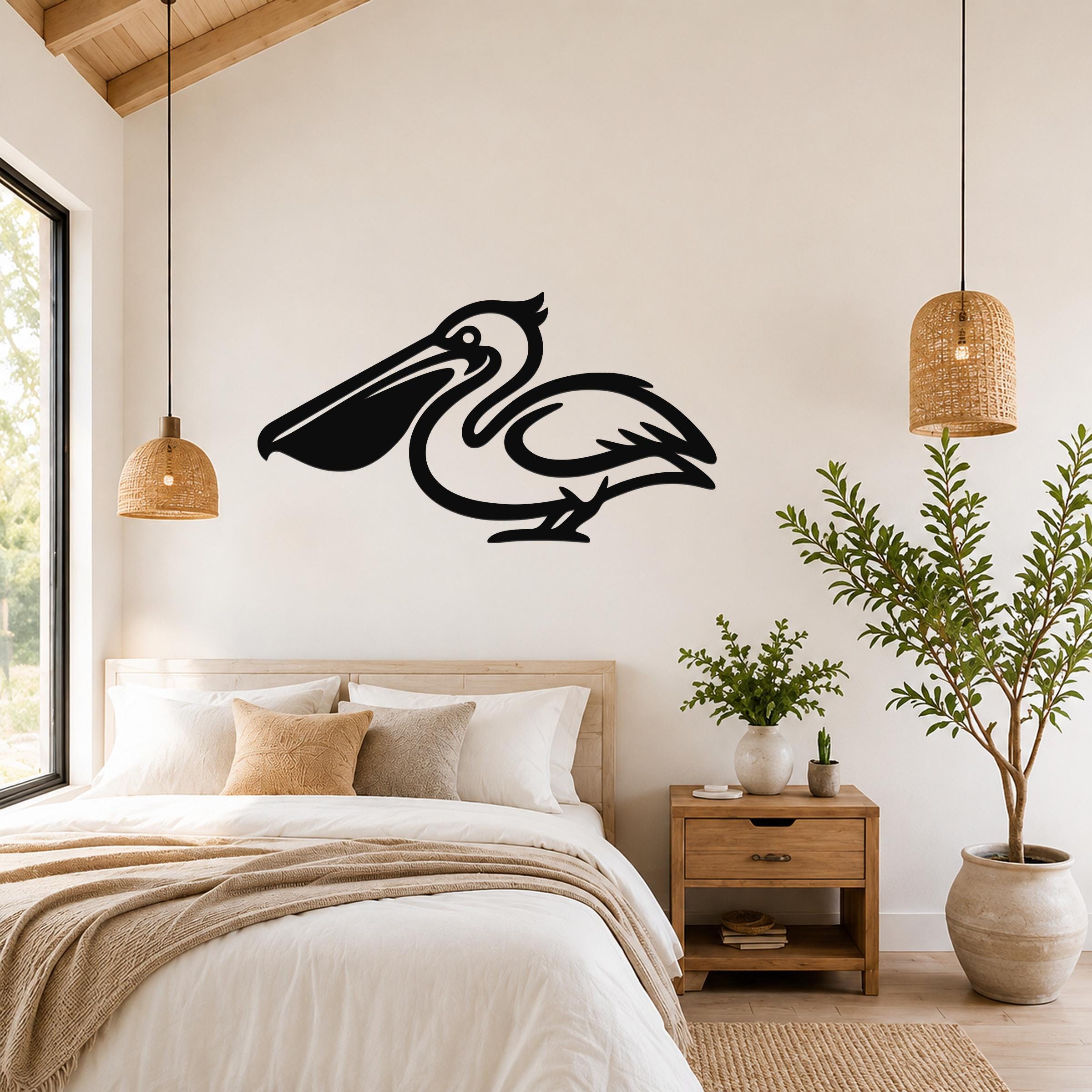 Black metal pelican wall art silhouette mounted above a bed in a bright bedroom with wooden ceiling and woven pendant lights.