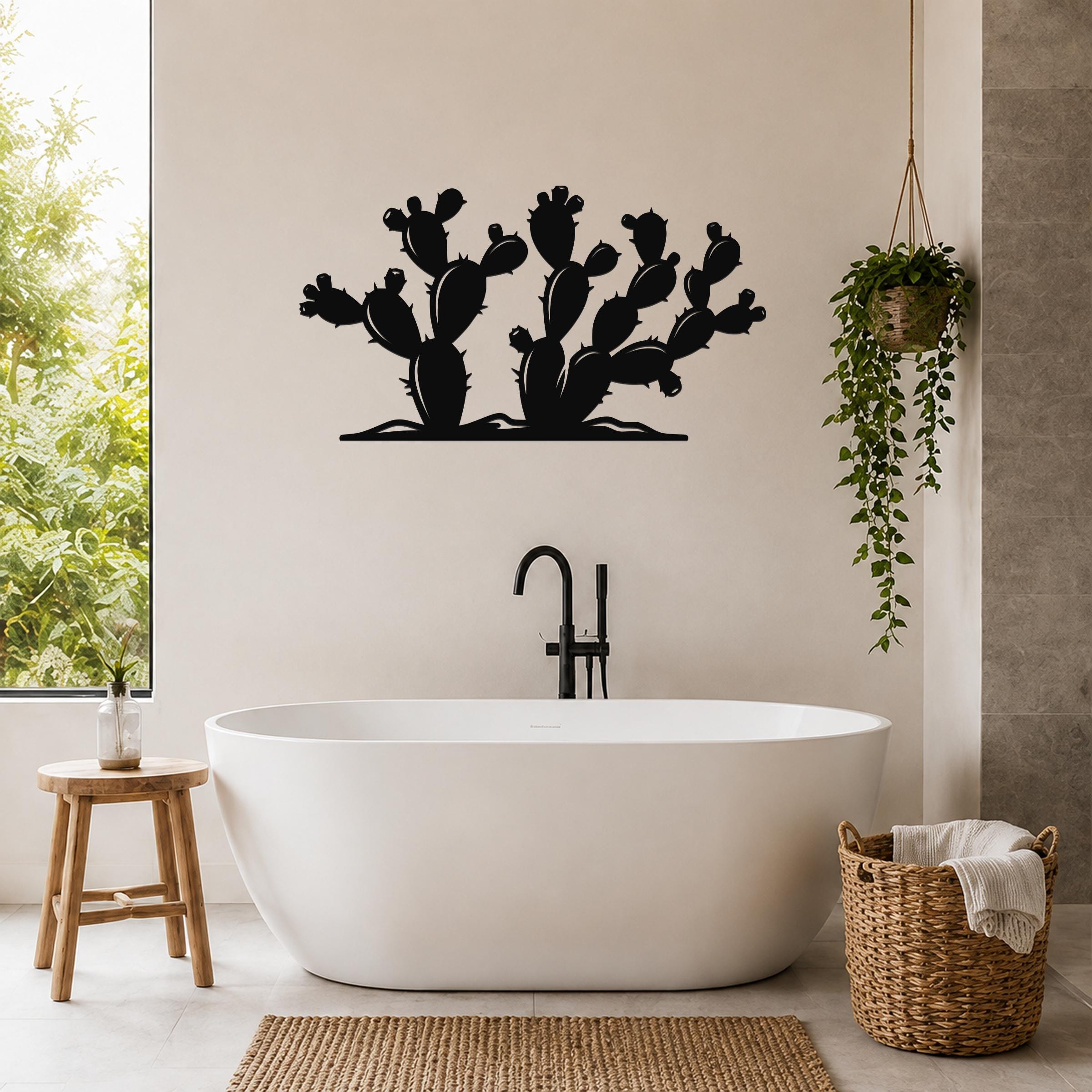 Black metal wall art in a prickly pear cactus silhouette, mounted above a freestanding bathtub in a modern bathroom.
