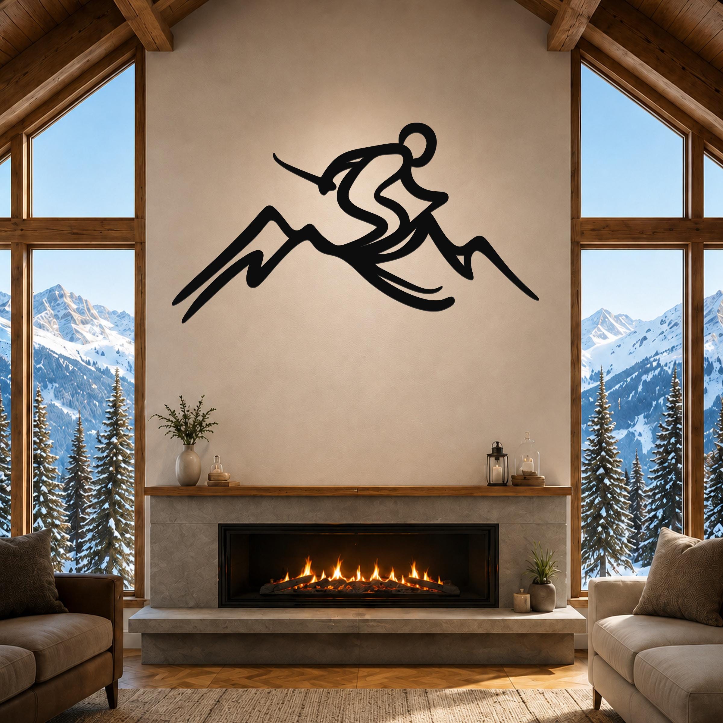 Black metal skier and mountain wall sculpture with dynamic flow lines, mounted above a fireplace in a living room with large windows and snowy mountain views.