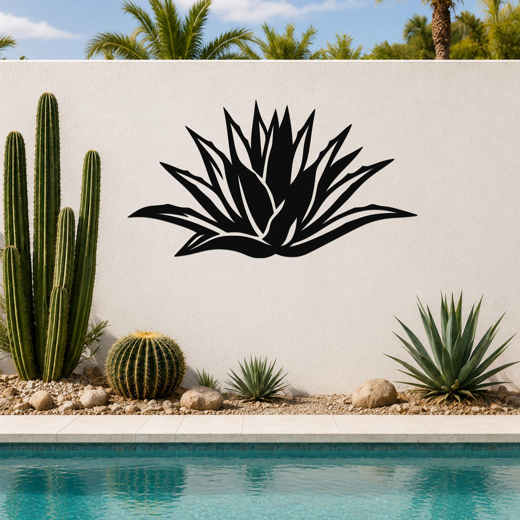 Black metal agave wall art with leaf cutouts, mounted on a white outdoor wall above a poolside garden.