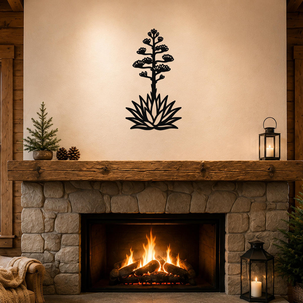 Black metal agave wall sculpture with blooming flower and spiky leaves, mounted above a stone fireplace in a rustic living room.