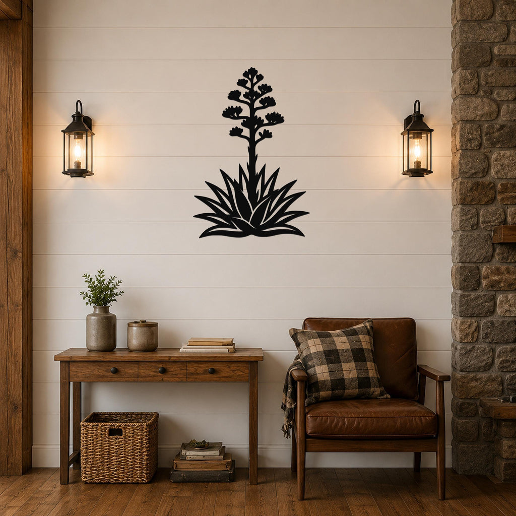 Black metal agave wall art with a blooming flower silhouette, mounted on a shiplap wall above a wooden console table in a living room.