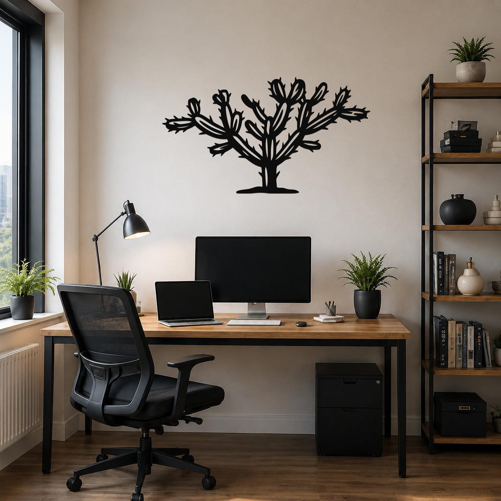 Black metal Cholla cactus wall art with branching spines and cutout details, mounted on a wall above a wooden desk in a home office.