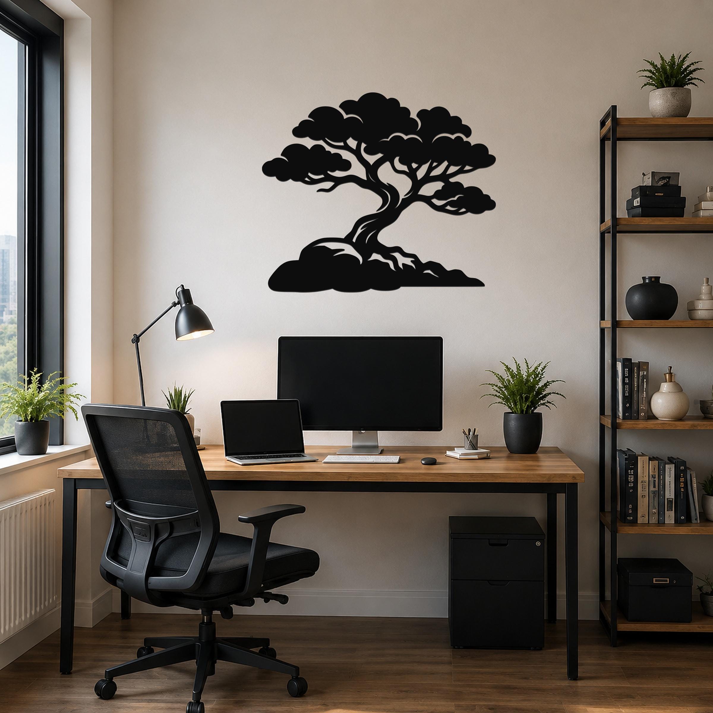 Black metal wall art in the silhouette of a bonsai-style juniper tree with detailed branches and roots, mounted on a wall above a wooden desk in a home office.