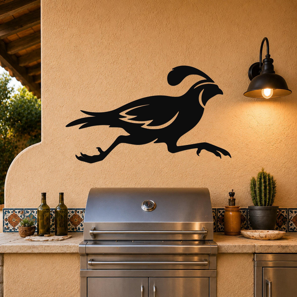 Black metal quail wall art in a running silhouette, mounted on an outdoor patio wall above a stainless steel grill.