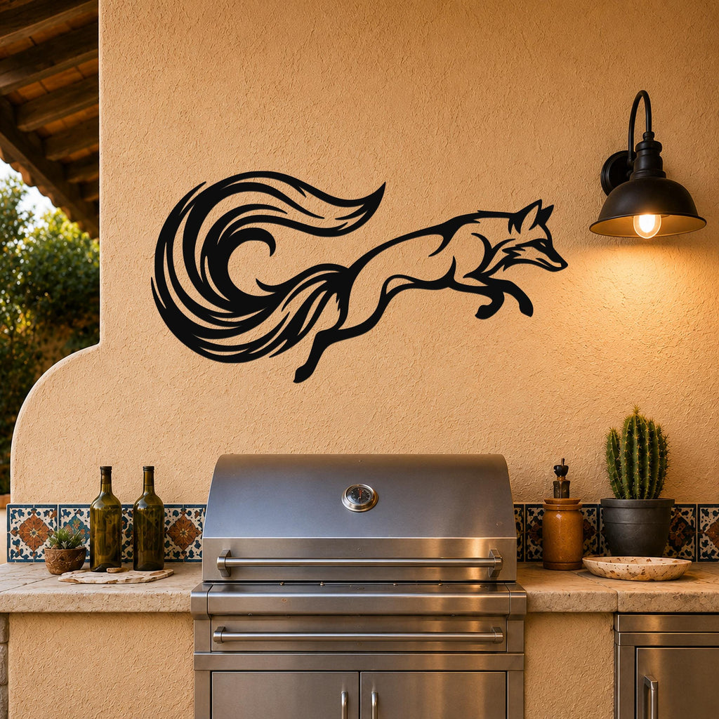 Black metal fox wall art with flowing tail silhouette, mounted on a stucco wall above an outdoor grill.