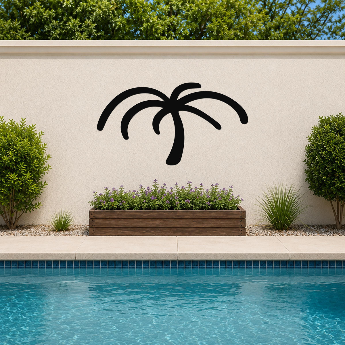 Black metal palm tree wall art silhouette mounted on a beige outdoor wall above a planter and pool.