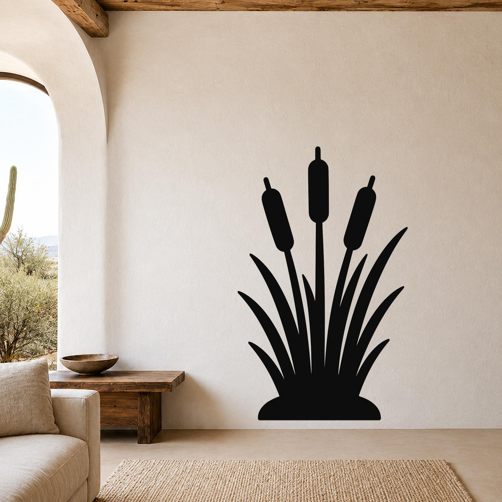 Black metal cattail wall art silhouette with three reeds and leafy base, mounted on a living room wall above a wooden bench.
